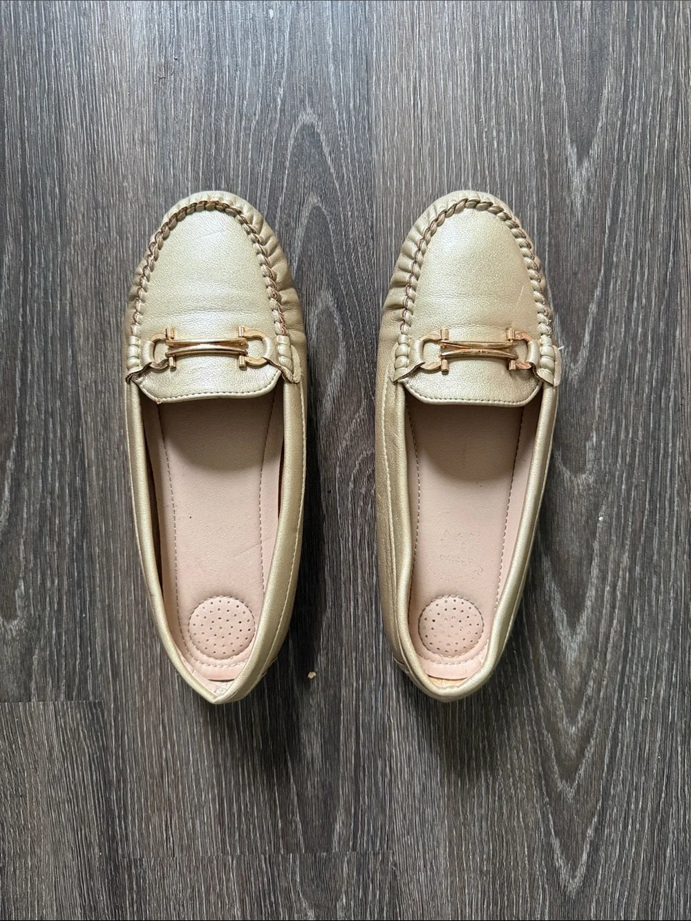 Women gold faux leather moccasin loafers featuring a rounded toe, light